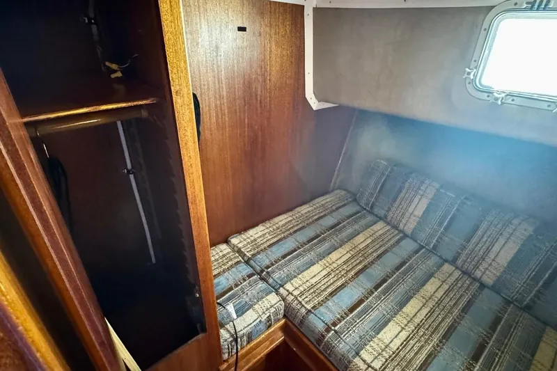 Slide: The Image of 1979 Californian 34 yacht cabin with plaid upholstery and wooden closet. - 34