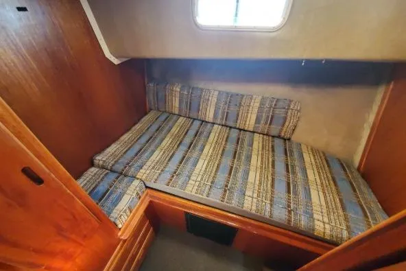 Slide: The Image of 1979 Californian 34 boat cabin with plaid cushions and wooden interior. - 37