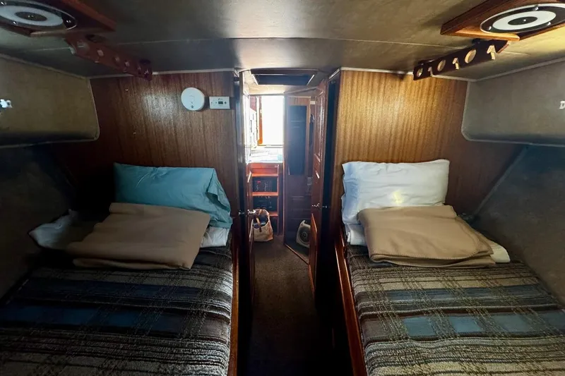 Slide: The Image of Cozy cabin interior of a 1979 Californian 34 boat with twin beds and wood paneling. - 38