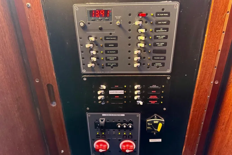 Slide: The Image of Electrical control panel on a 1979 Californian 34 boat, featuring switches and indicators. - 39