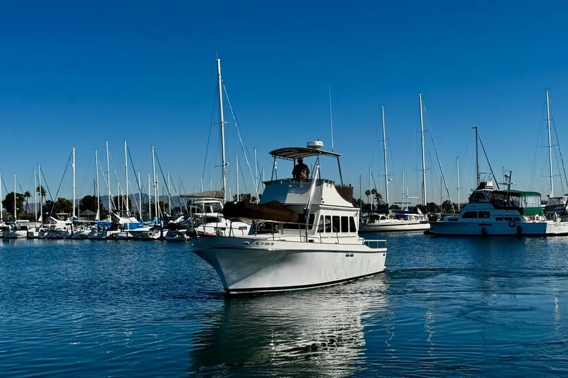 Slide: The Image of 1979 Californian 34 yacht cruising in a marina with sailboats in the background. - 5