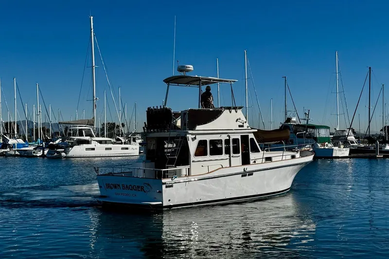 Slide: The Image of 1979 Californian 34 boat in marina, surrounded by sailboats under clear blue sky. - 8