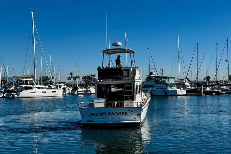 Slide: The Image of 1979 Californian 34 boat "Brown Bagger" in San Pedro marina, surrounded by sailboats. - 9