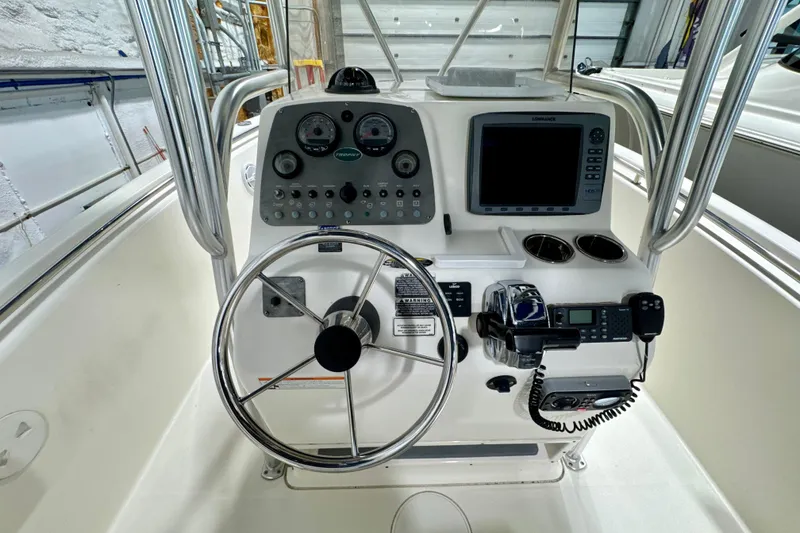 Slide: The Image of Center console of 2010 Trophy 2203 boat with steering wheel and navigation equipment. - 10