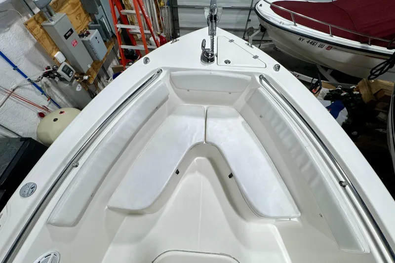 Slide: The Image of 2010 Trophy 2203 Center Console boat interior with white seating and stainless steel rails. - 13