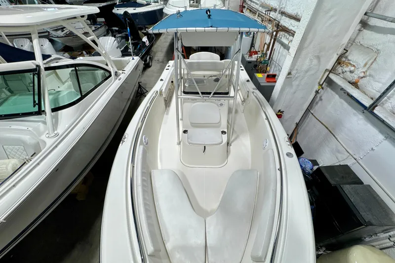 Slide: The Image of 2010 Trophy 2203 Center Console boat with blue canopy in storage facility. - 14