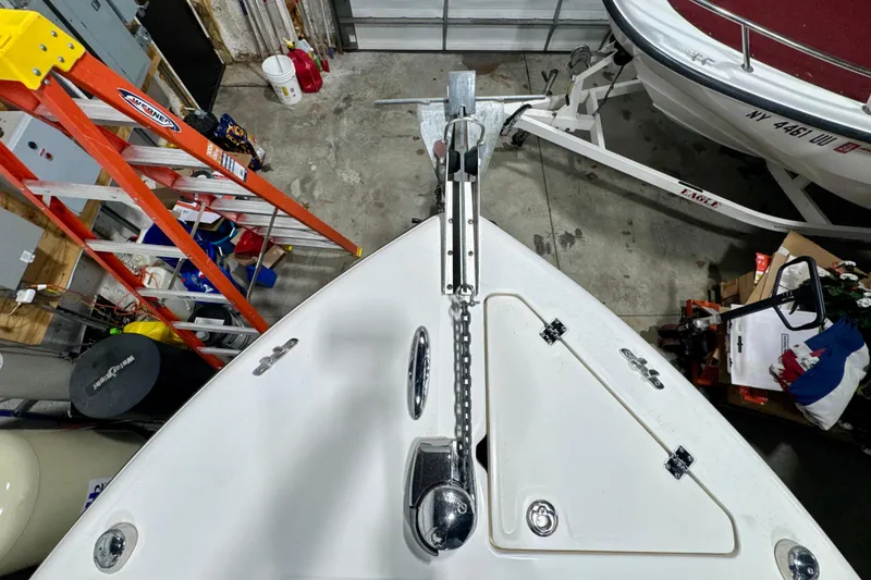 Slide: The Image of Bow view of 2010 Trophy 2203 Center Console boat in a garage setting. - 15