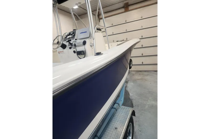 Slide: The Image of 2010 Trophy 2203 Center Console boat in garage, featuring Lowrance equipment. - 18