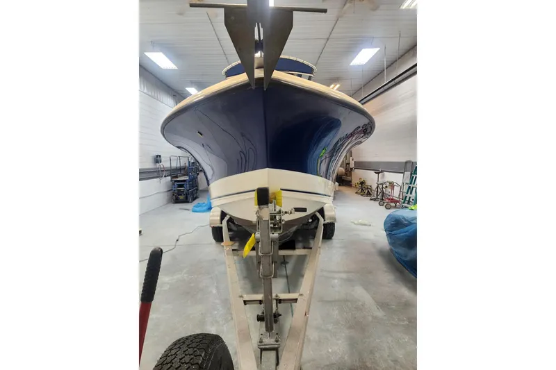 Slide: The Image of 2010 Trophy 2203 Center Console boat on trailer in indoor storage. - 19