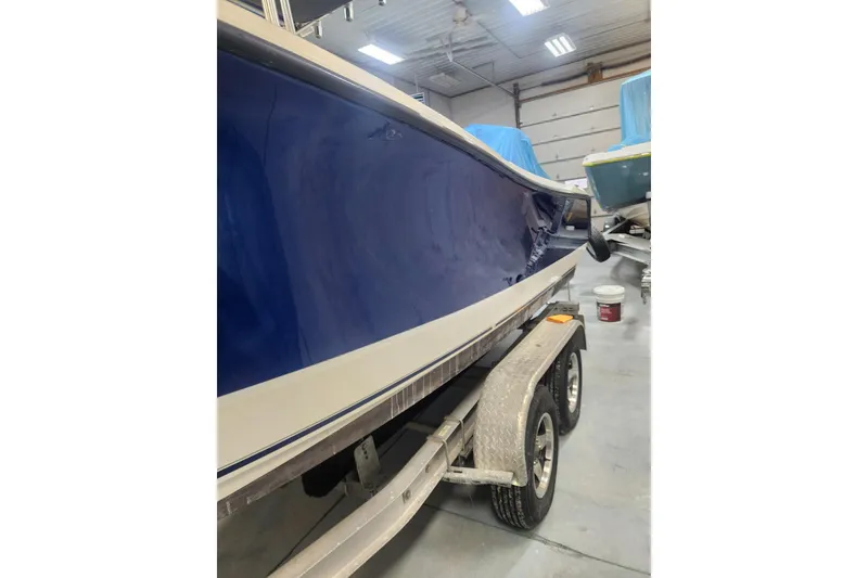 Slide: The Image of 2010 Trophy 2203 Center Console boat on trailer in garage. - 20