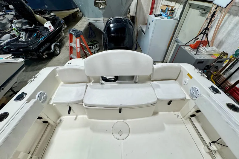 Slide: The Image of 2010 Trophy 2203 Center Console boat interior with seating and storage in a garage. - 7
