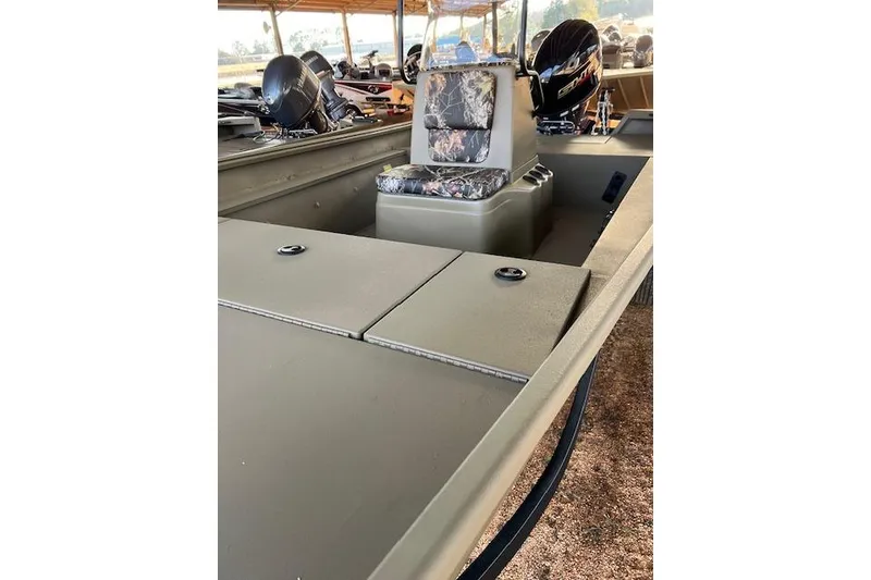 Slide: The Image of 2026 G3 Gator Tough 18 CC DLX boat interior with camouflage seating and storage compartments. - 3