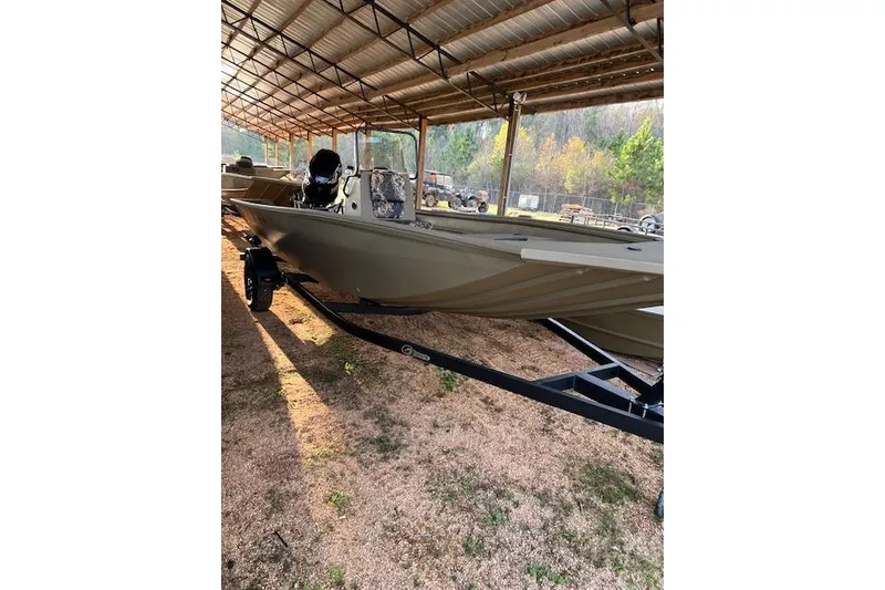 Slide: The Image of 2026 G3 Gator Tough 18 CC DLX boat under a metal canopy. - 6