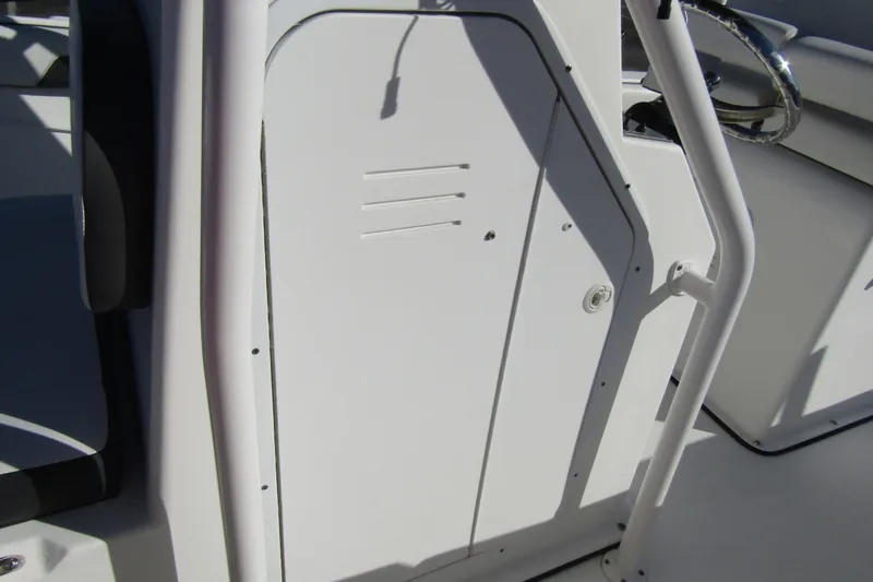 Slide: The Image of 2019 Clearwater Sportfishing Boats 2200 CC console detail with white finish and steering wheel. - 15