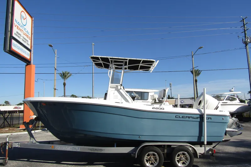 The Image of 2019 Clearwater Sportfishing Boats 2200 CC on trailer at dealership, clear blue sky. - 0