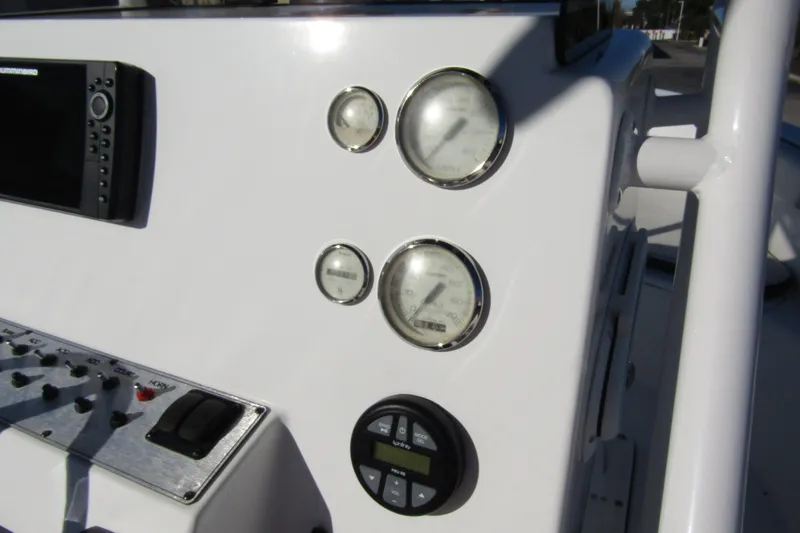 Slide: The Image of Control panel of 2019 Clearwater Sportfishing Boats 2200 CC with gauges and electronics. - 18