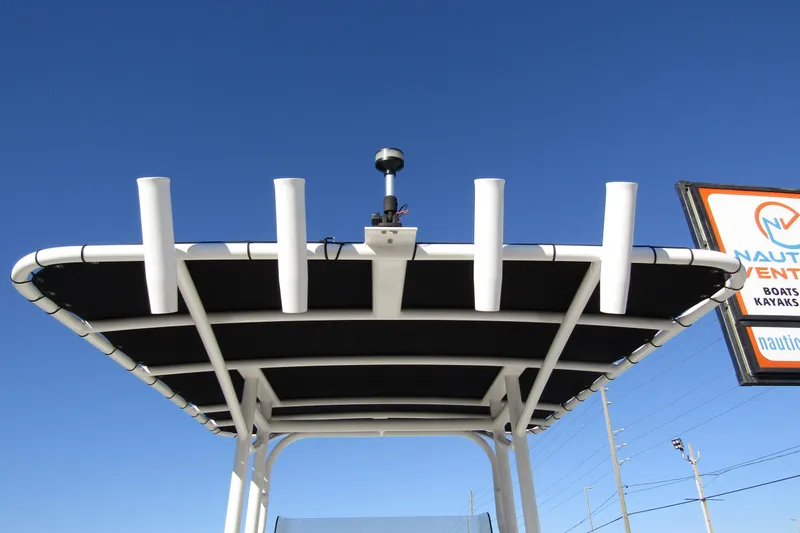 Slide: The Image of T-top of 2019 Clearwater Sportfishing Boats 2200 CC against clear blue sky. - 28