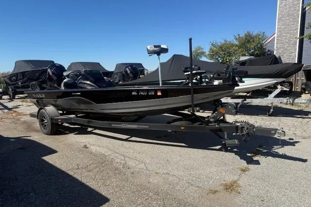 Slide: The Image of 2023 Vexus AVX1880 boat on trailer, parked outdoors under clear blue sky. - 0