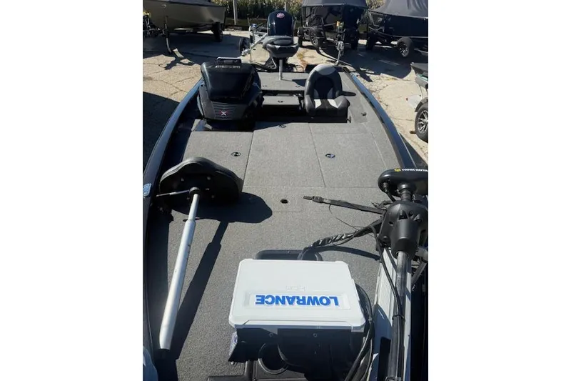 Slide: The Image of 2023 Vexus AVX1880 fishing boat with Lowrance equipment, parked outdoors. - 1