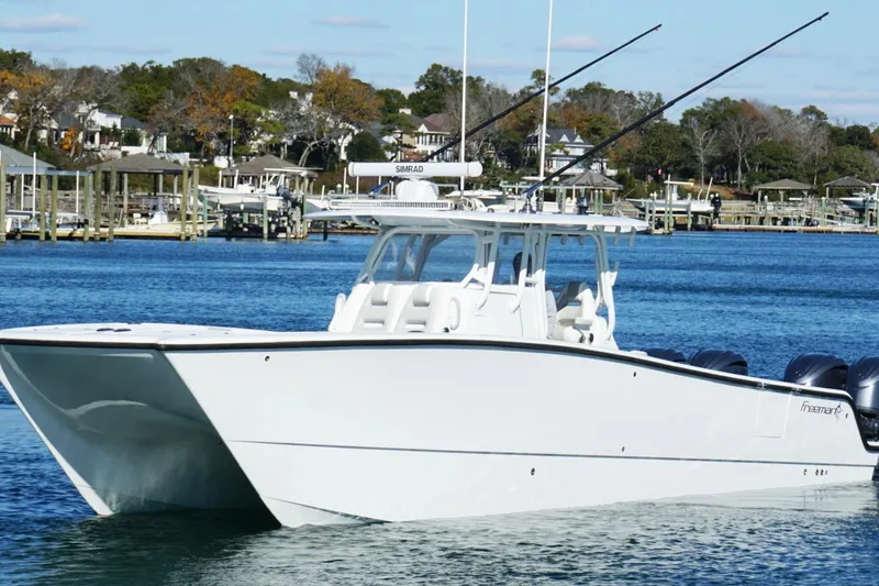 Slide: The Image of 2024 Freeman 38 boat on water, featuring sleek design and multiple engines. - 11