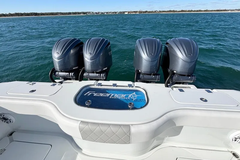 Slide: The Image of 2024 Freeman 38 boat with four powerful outboard motors on open water. - 18