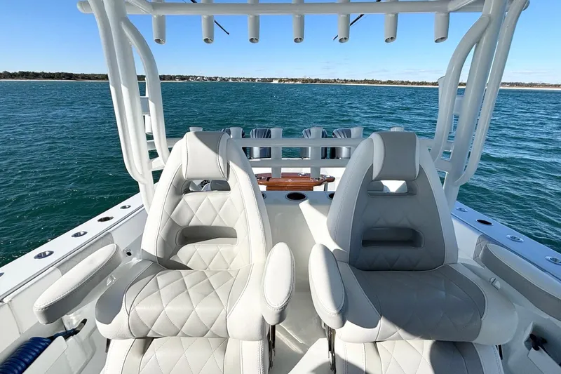 Slide: The Image of Luxury seating on a 2024 Freeman 38 boat, overlooking serene ocean waters. - 19