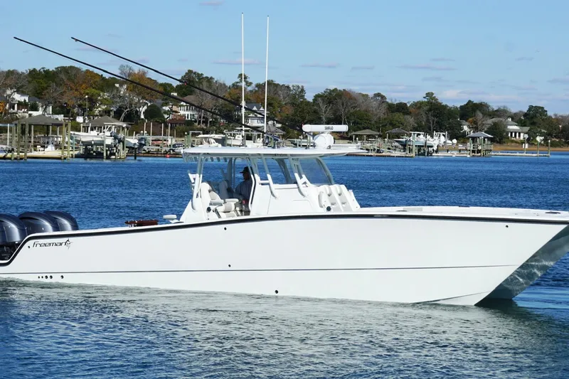 Slide: The Image of 2024 Freeman 38 boat cruising on a calm blue waterway. - 5