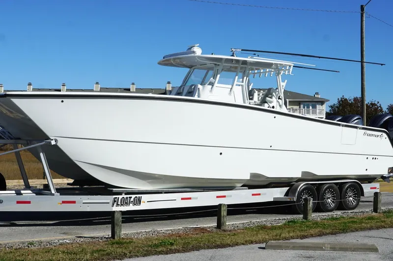 Slide: The Image of 2024 Freeman 38 boat on trailer, sleek design, ready for adventure. - 6