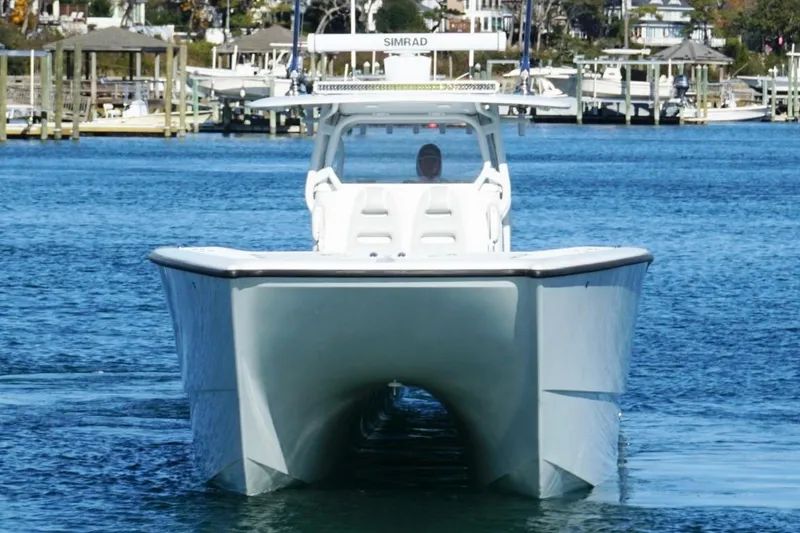 Slide: The Image of 2024 Freeman 38 boat on water, front view, with marina background. - 7