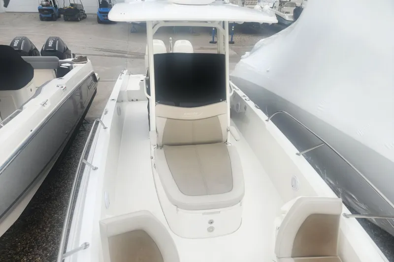 Slide: The Image of 2018 Boston Whaler 270 Dauntless boat with seating and canopy, docked outdoors. - 10