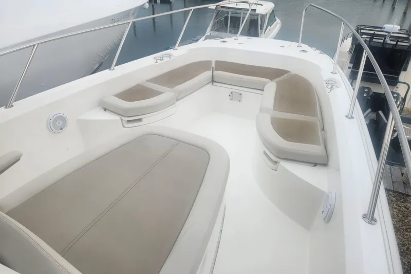 Slide: The Image of 2018 Boston Whaler 270 Dauntless boat interior with cushioned seating and stainless steel railings. - 11