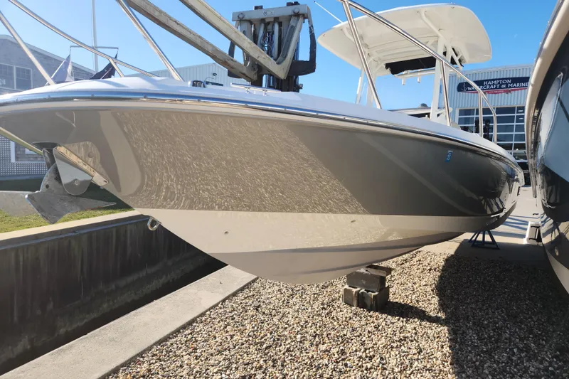 Slide: The Image of 2018 Boston Whaler 270 Dauntless boat displayed outdoors on gravel. - 13