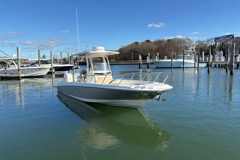 Slide: The Image of 2018 Boston Whaler 270 Dauntless boat docked in a marina under clear blue skies. - 15