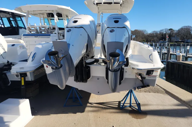 Slide: The Image of 2018 Boston Whaler 270 Dauntless with dual outboard engines on a dock. - 3