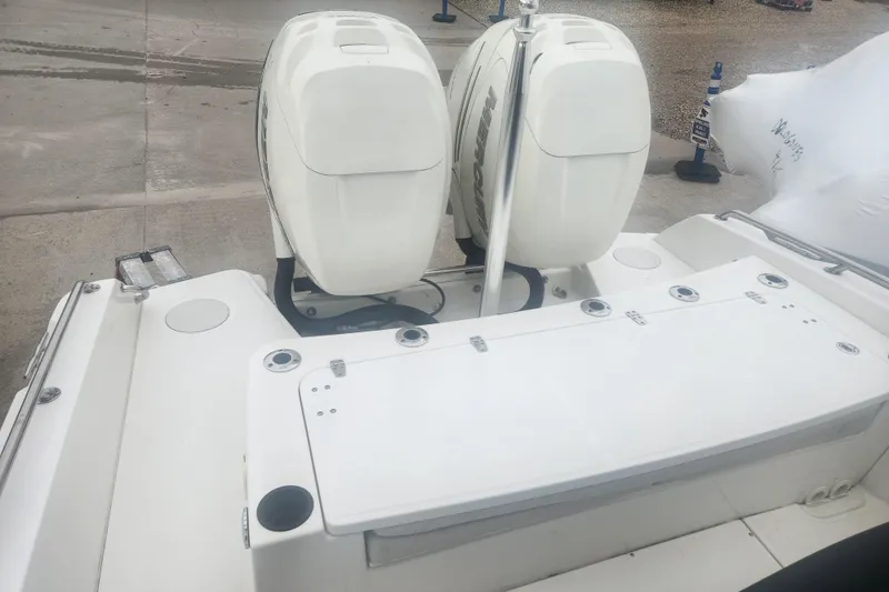 Slide: The Image of 2018 Boston Whaler 270 Dauntless boat with dual outboard engines, docked on concrete. - 4