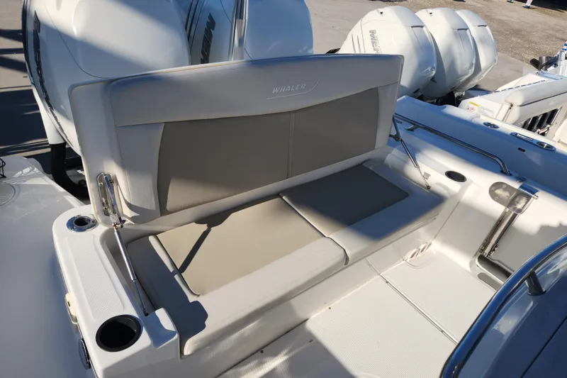 Slide: The Image of 2018 Boston Whaler 270 Dauntless boat interior with cushioned seating and cup holders. - 5