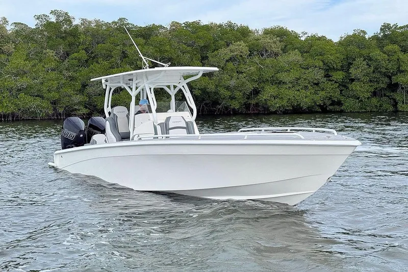 Slide: The Image of 2023 Concept 30' Cuddy Cabin boat on water, surrounded by lush greenery. - 0