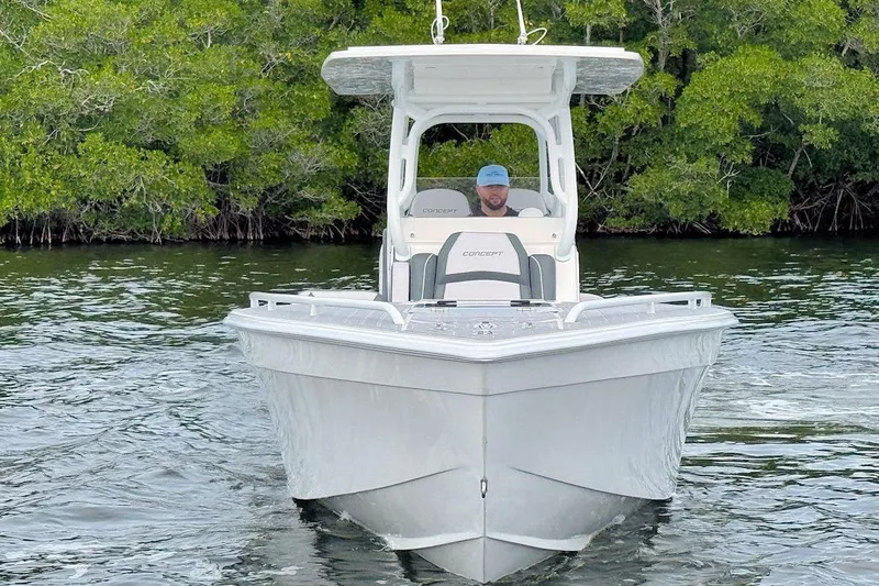 Slide: The Image of 2023 Concept 30' Cuddy Cabin boat on water, surrounded by lush greenery. - 1