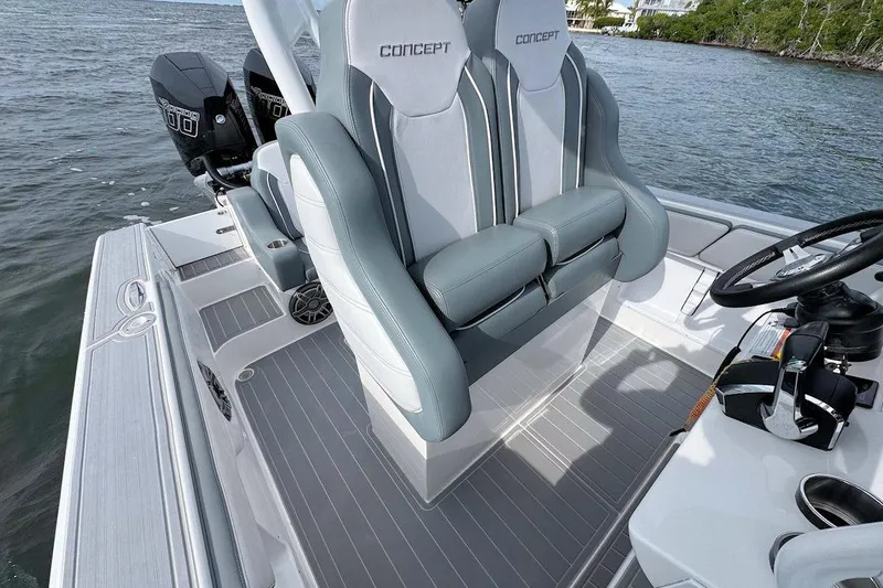 Slide: The Image of 2023 Concept 30' Cuddy Cabin boat interior with dual seats and steering wheel. - 11
