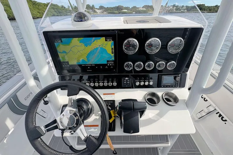 Slide: The Image of 2023 Concept 30' Cuddy Cabin boat dashboard with navigation screen and controls. - 15