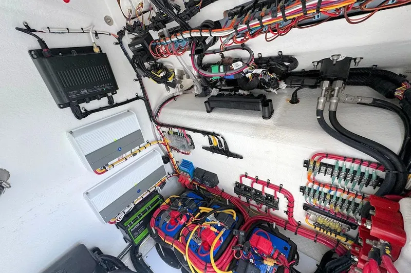 Slide: The Image of Electrical wiring system inside 2023 Concept 30' Cuddy Cabin boat, showcasing organized cables and components. - 16