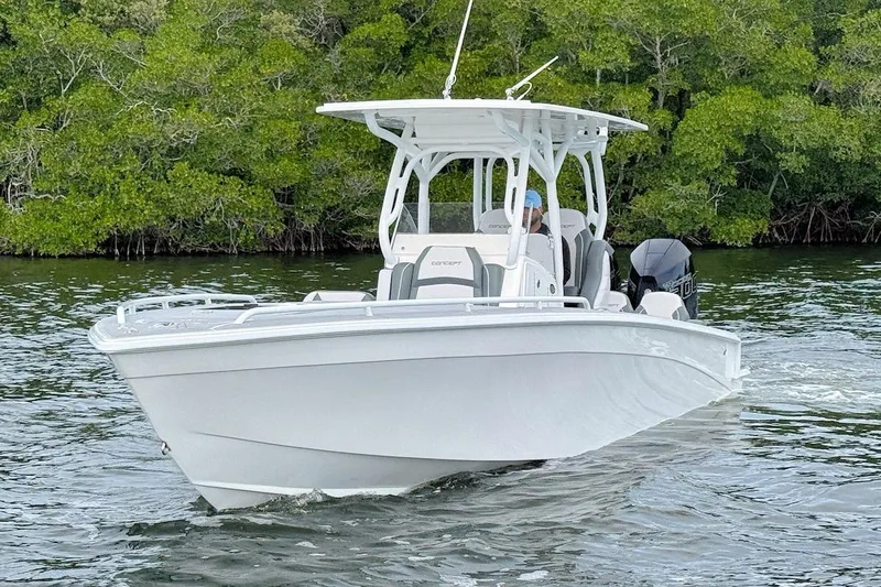 Slide: The Image of 2023 Concept 30' Cuddy Cabin boat cruising on water near lush greenery. - 2