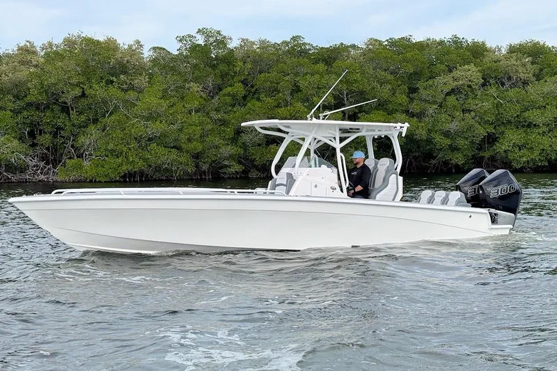 Slide: The Image of 2023 Concept 30' Cuddy Cabin boat cruising on water near lush greenery. - 3