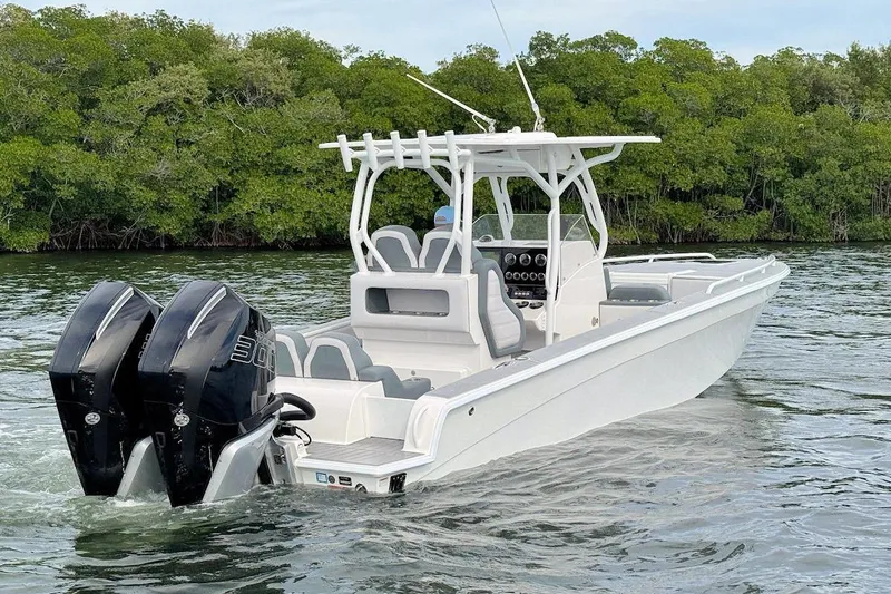 Slide: The Image of 2023 Concept 30' Cuddy Cabin boat with dual engines on a serene waterway. - 5