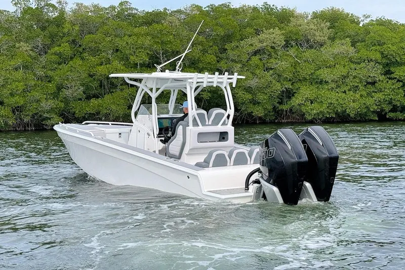 Slide: The Image of 2023 Concept 30' Cuddy Cabin boat cruising on water near lush greenery. - 8