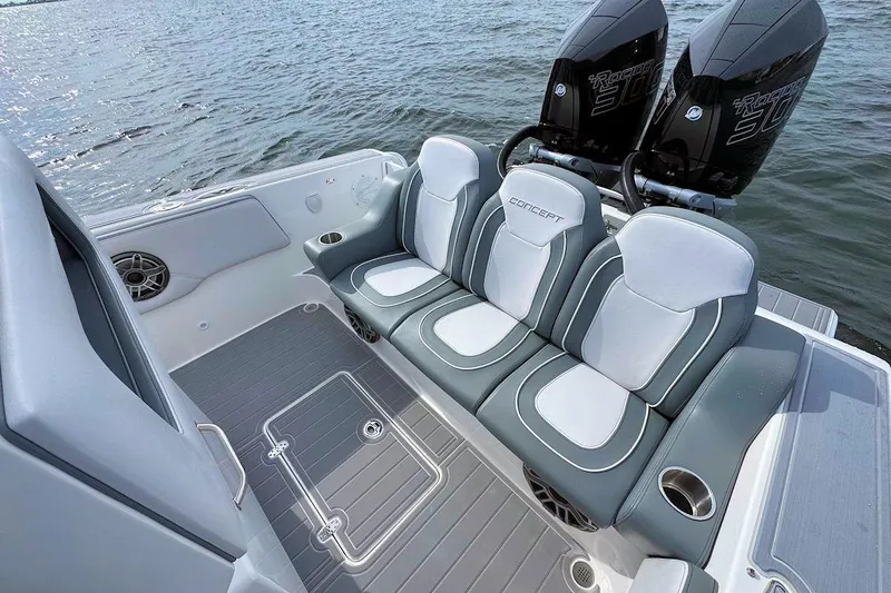 Slide: The Image of 2023 Concept 30' Cuddy Cabin boat interior with cushioned seating and twin engines on water. - 9