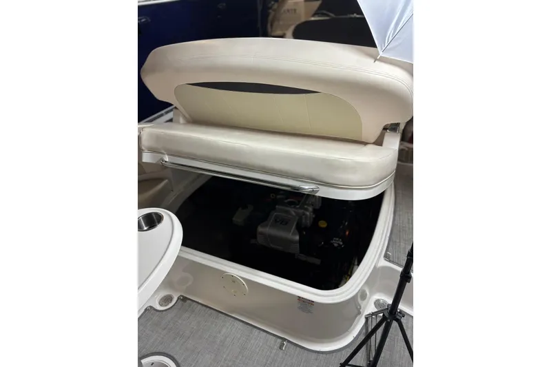 Slide: The Image of 2016 Chaparral 287 SSX boat interior showing engine compartment under seat. - 12
