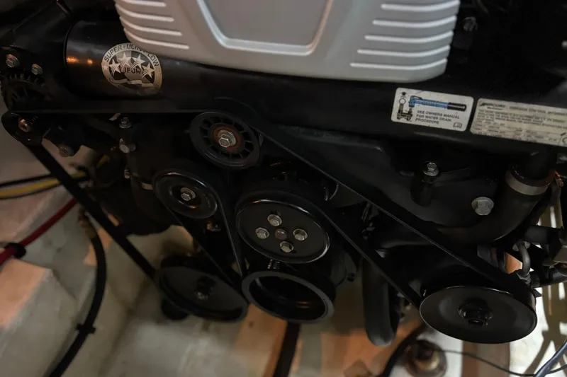 Slide: The Image of Engine components of a 2016 Chaparral 287 SSX boat, featuring belts and pulleys. - 13