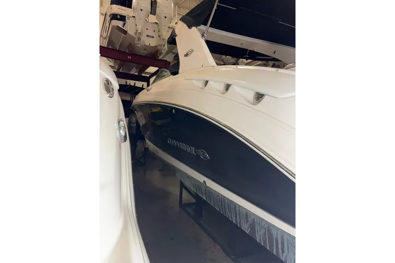 Slide: The Image of 2016 Chaparral 287 SSX boat in storage, showcasing sleek design and white exterior. - 17