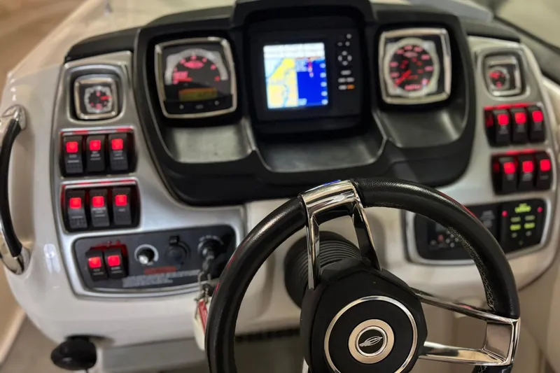 Slide: The Image of Dashboard of a 2016 Chaparral 287 SSX boat with steering wheel and control panel. - 2
